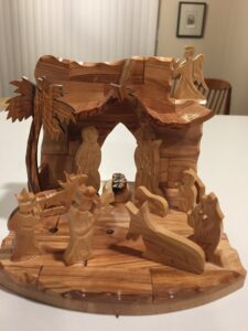 An olive wood nativity set with the separation wall now vanished. 
