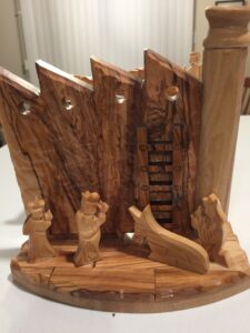 An olive wood nativity set with the separation wall running through the middle. 